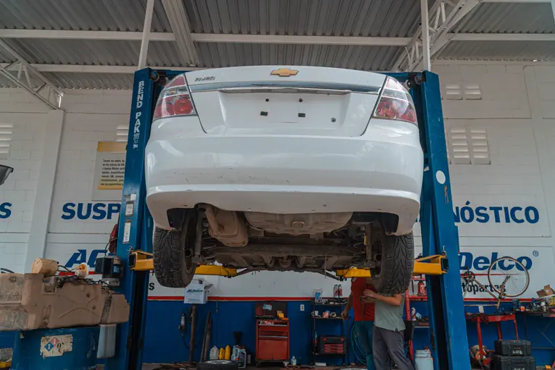 Auto elevado en el taller para revisión